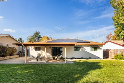 a front view of a house with a garden and patio