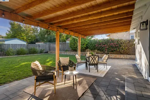a patio with yard table and chairs