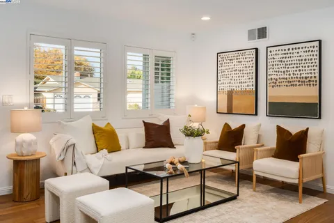 a living room with furniture and large windows