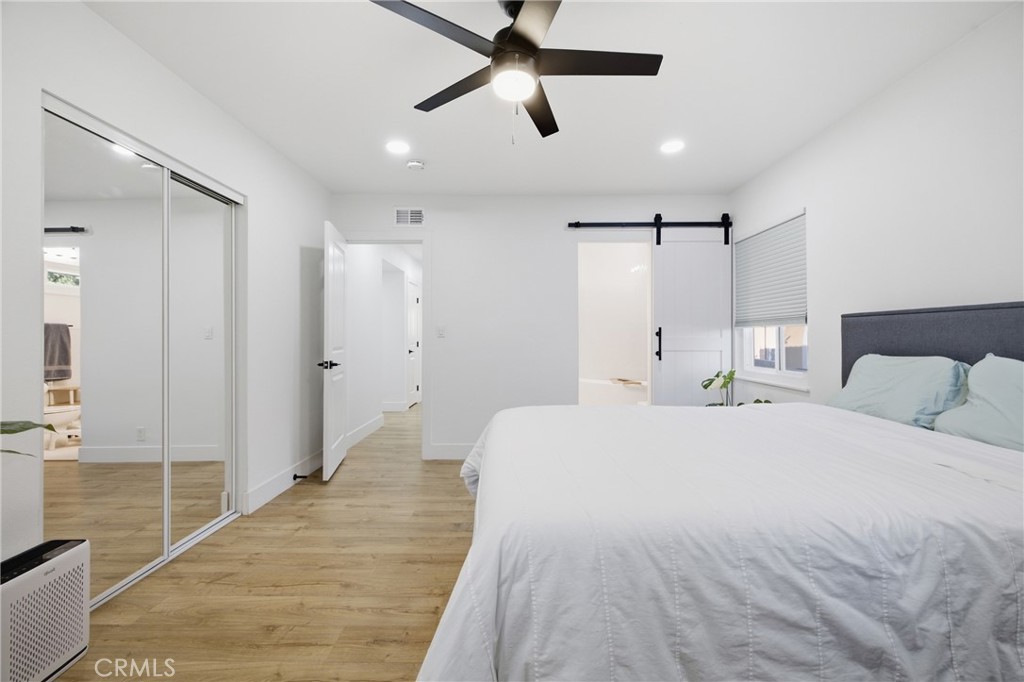 384 Colorado Street Arcadia, CA 91007 - Photo 35 of 51 a spacious bedroom with a bed and a chandelier