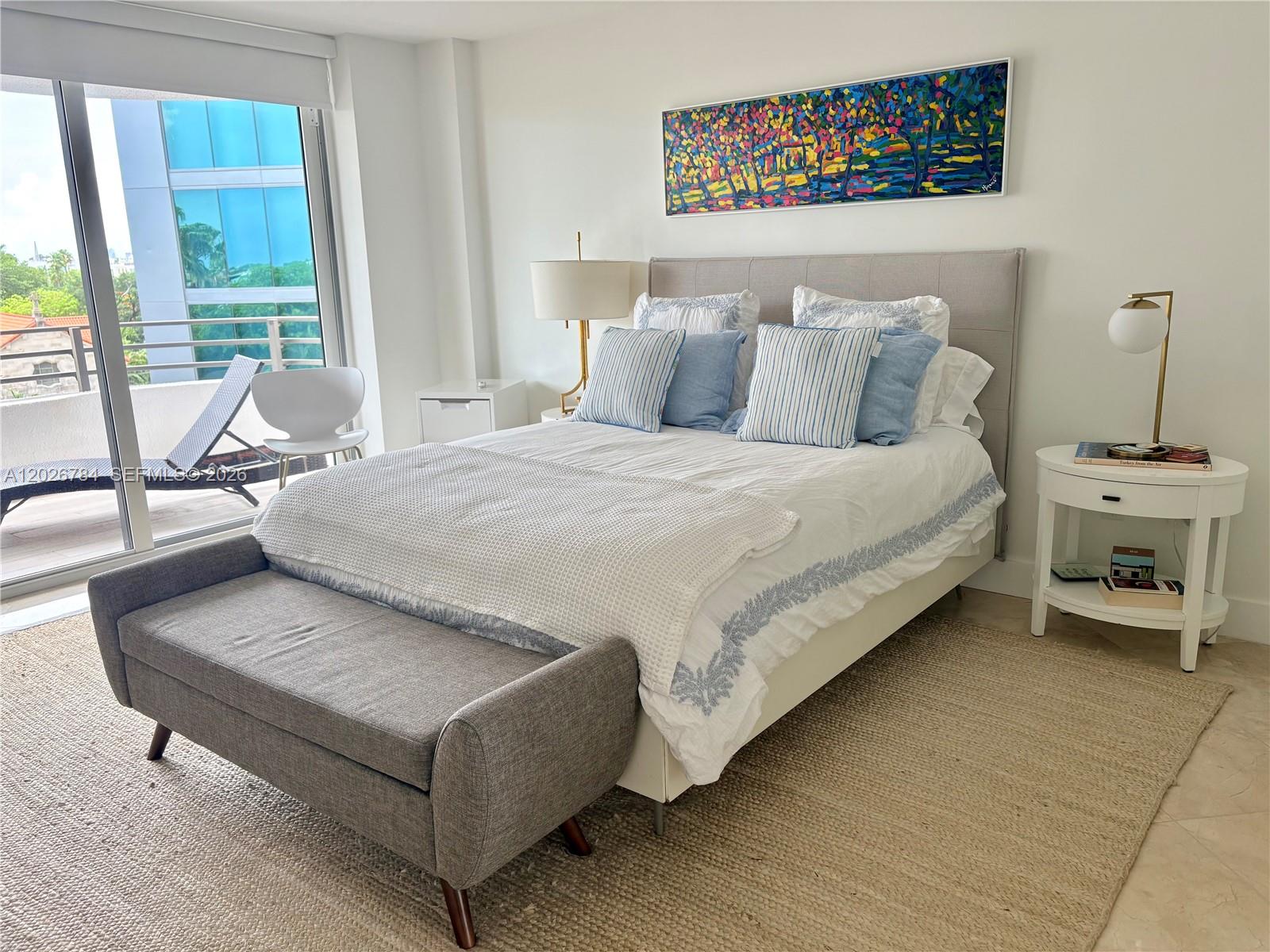 151 Southeast 15th Road, Unit 601 Miami, FL 33129 - Photo 17 of 36 a bedroom with a bed and a table