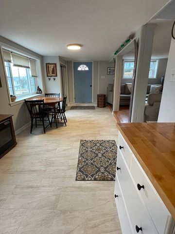 a living room with furniture a dining table and a piano table with wooden floor