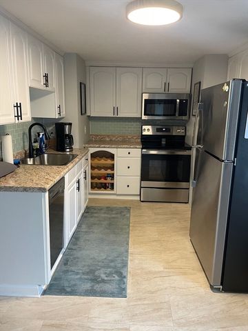 a kitchen with stainless steel appliances granite countertop a stove sink and refrigerator
