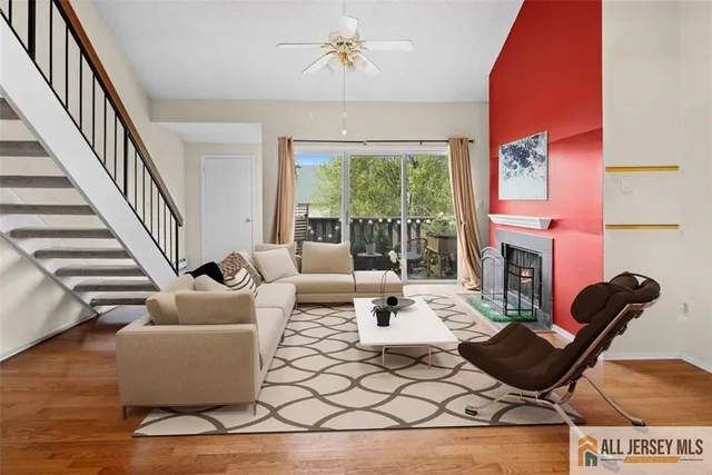 a living room with furniture a fireplace and a chandelier