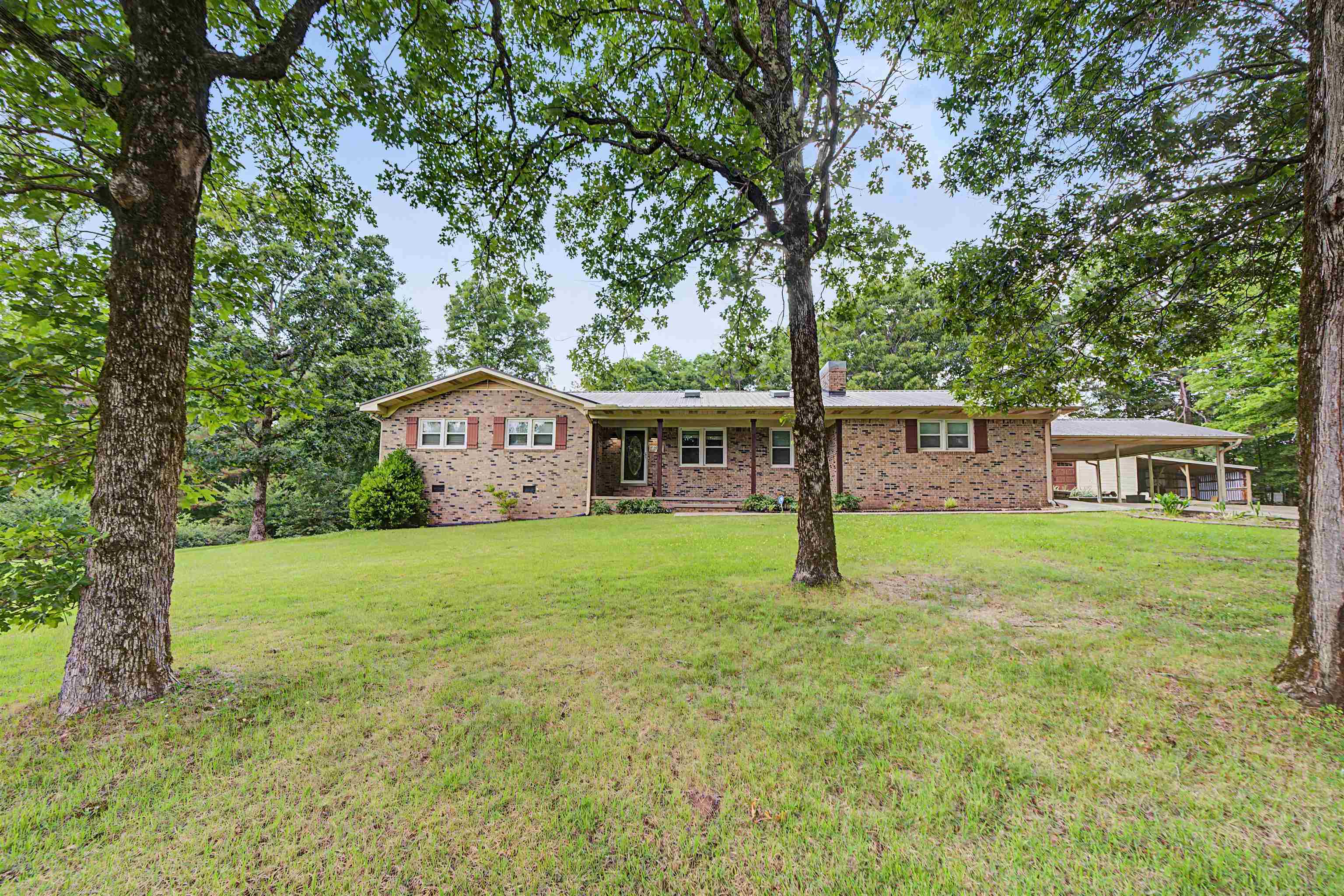 436 Skyline Road Selmer, TN 38375 - Photo 7 of 40 Brick ranch-style residence featuring a wide front lawn and mature trees
