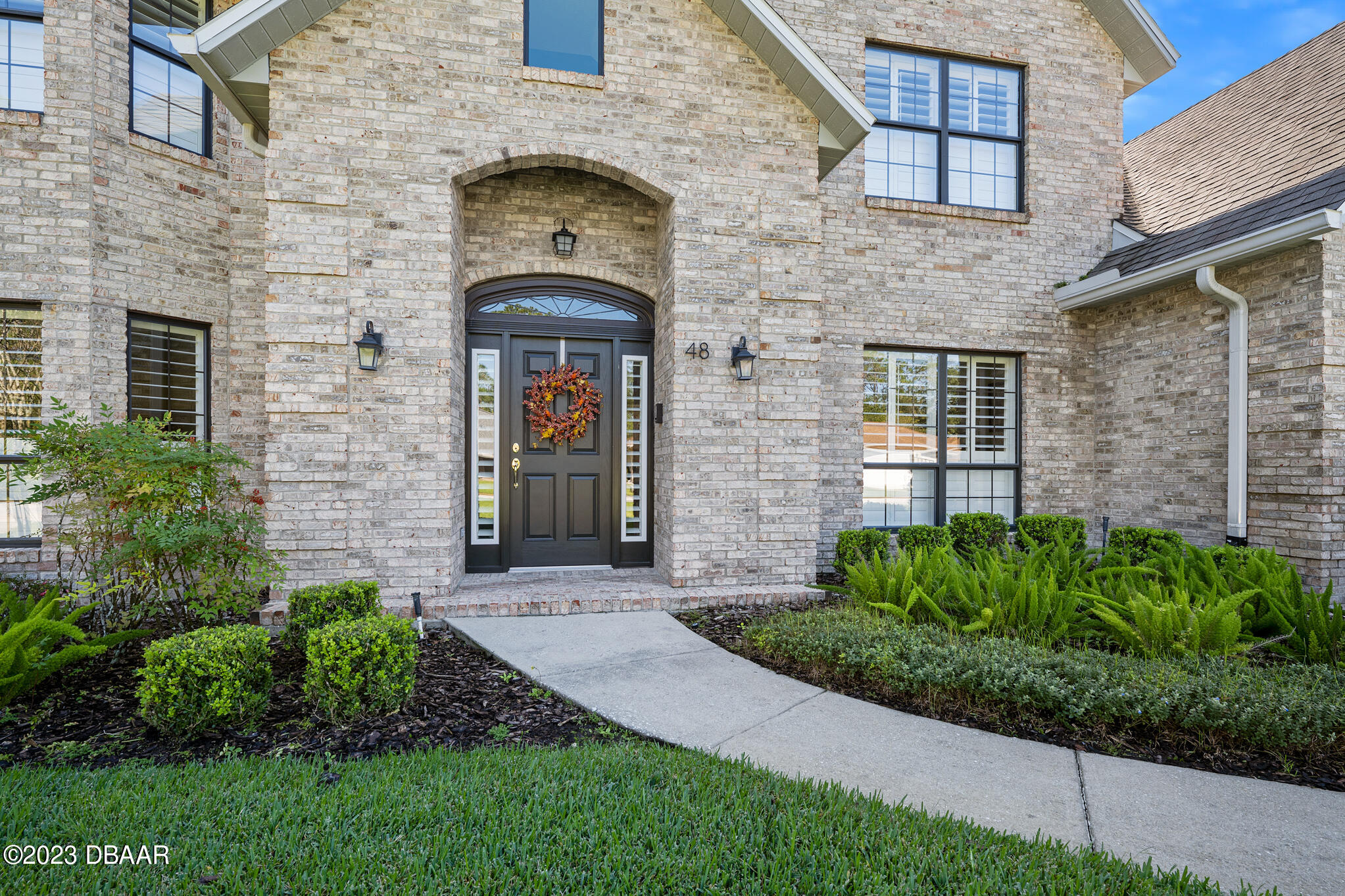48 Winding Creek Way Ormond Beach, FL 32174 - Photo 2 of 11 a front view of a house with a garden