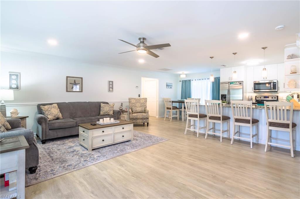 28 Constitution Drive Naples, FL 34112 - Photo 15 of 30 a living room with lots of furniture and view of kitchen