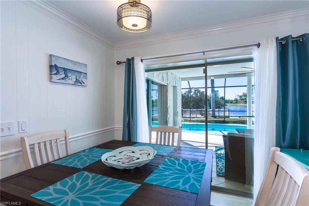 28 Constitution Drive Naples, FL 34112 - Photo 17 of 30 a view of a dining room with furniture large windows and wooden floor