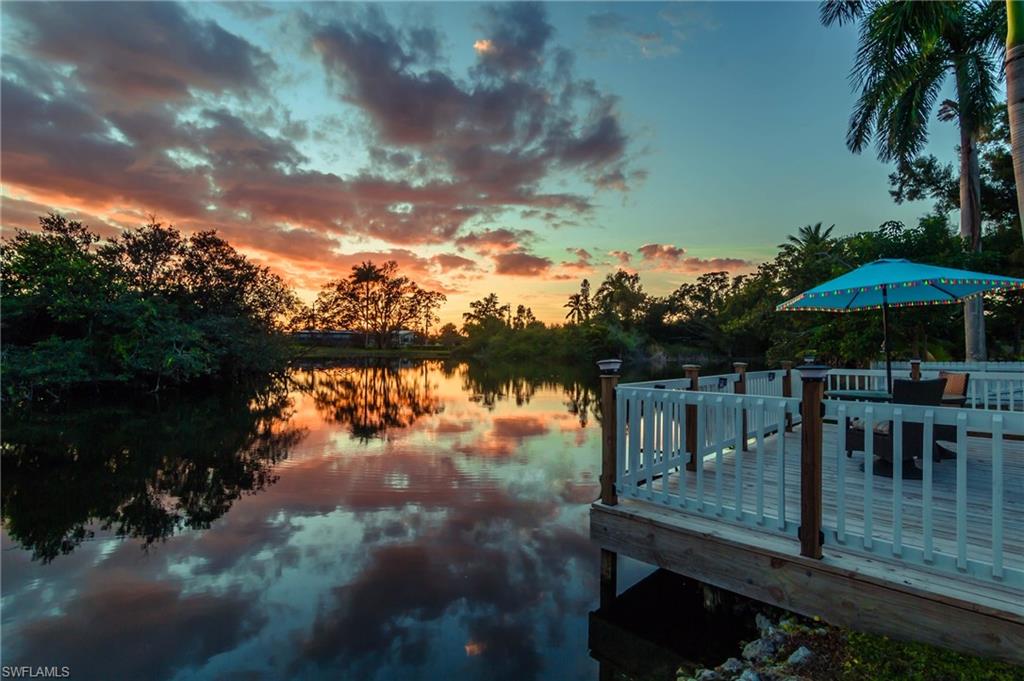28 Constitution Drive Naples, FL 34112 - Photo 24 of 30 a view of a lake with sitting area