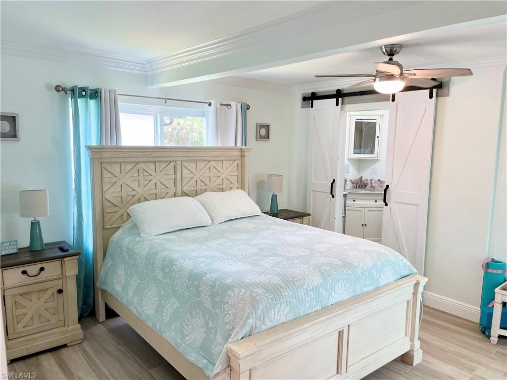 28 Constitution Drive Naples, FL 34112 - Photo 25 of 30 a bedroom with a bed and wooden floor