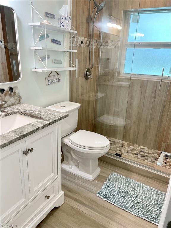 28 Constitution Drive Naples, FL 34112 - Photo 28 of 30 a bathroom with a granite countertop sink toilet and shower