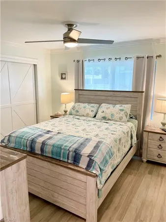 a bedroom with two beds and a chandelier