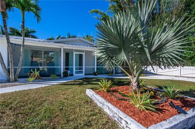 a view of a house with backyard sitting area and swimming pool