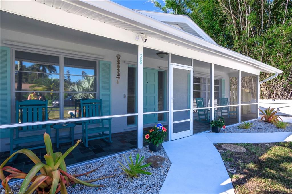 28 Constitution Drive Naples, FL 34112 - Photo 4 of 30 a view of a chair and table in backyard of the house