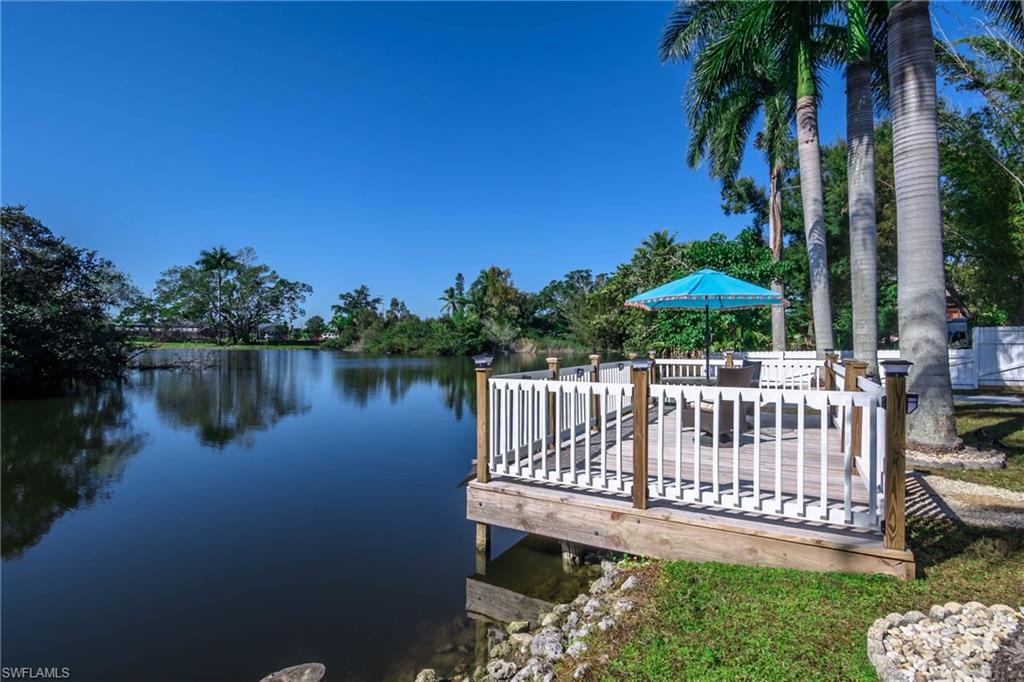 28 Constitution Drive Naples, FL 34112 - Photo 5 of 30 a view of a wooden deck with a bench