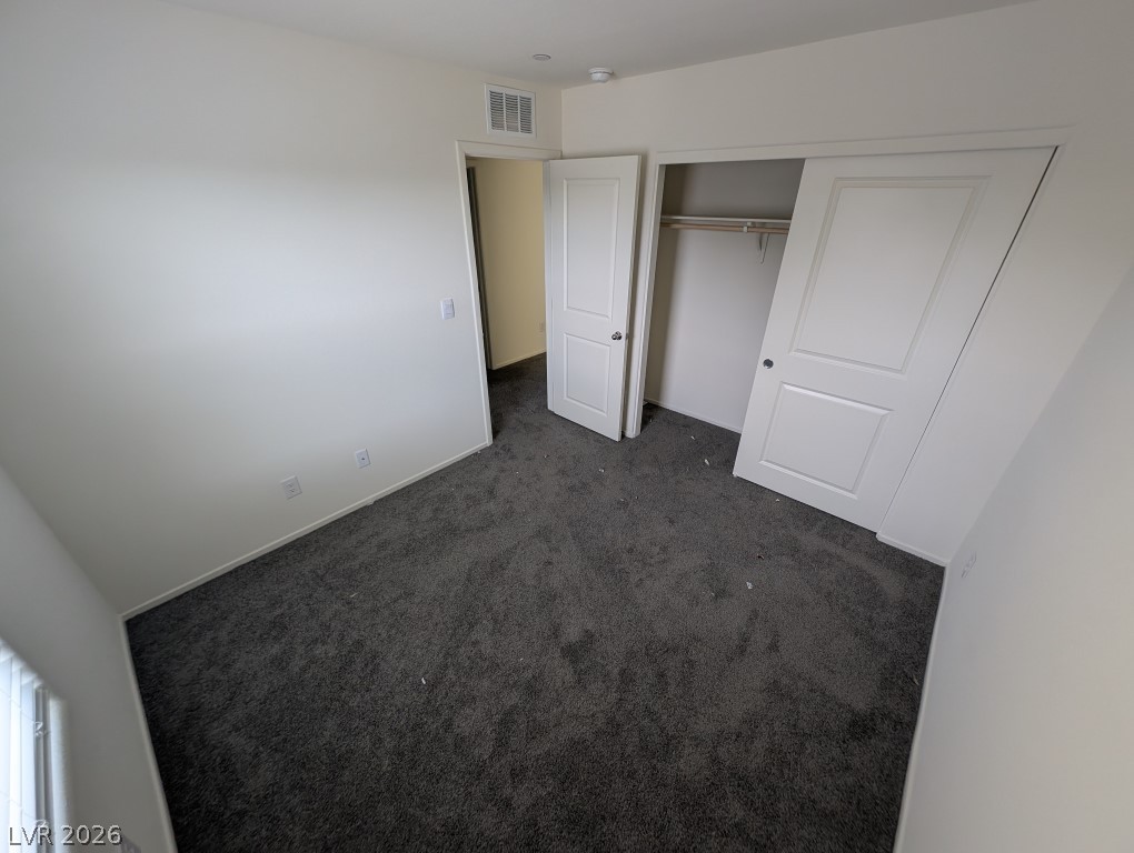 4820 Orchid Rdg Avenue Las Vegas, NV 89141 - Photo 12 of 16 An inviting sleeping space with ample floor area and a dedicated closet for organization.