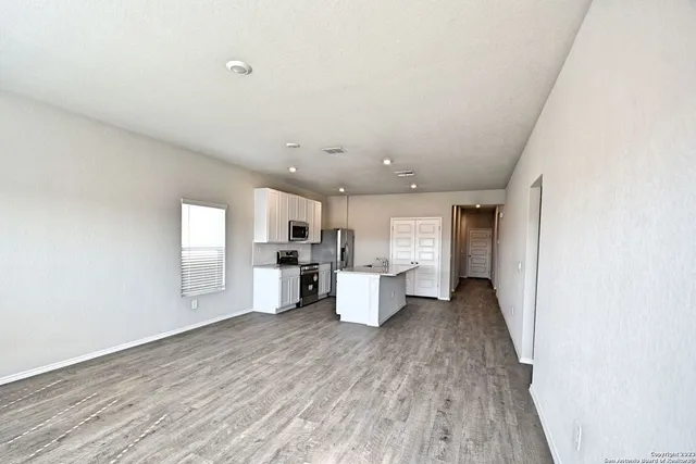 a view of a kitchen with a sink a window and stainless steel appliances