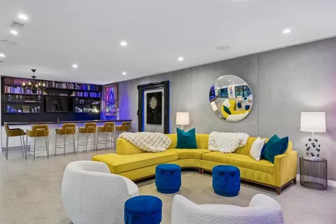 a living room with furniture and kitchen view