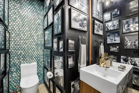 a bathroom with a sink a toilet and mirror