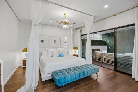 a bedroom with a bed and a chandelier