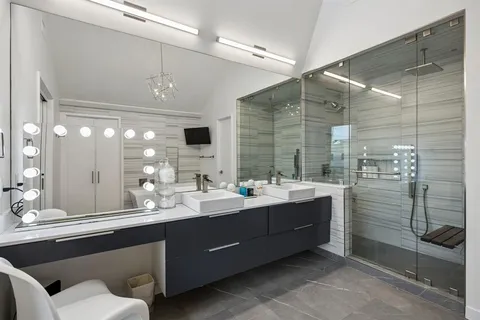 a bathroom with a double vanity sink mirror and double