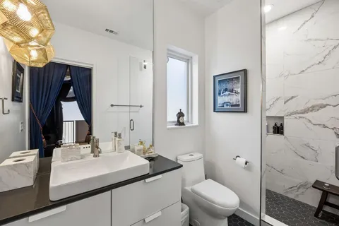 a bathroom with a sink toilet and shower