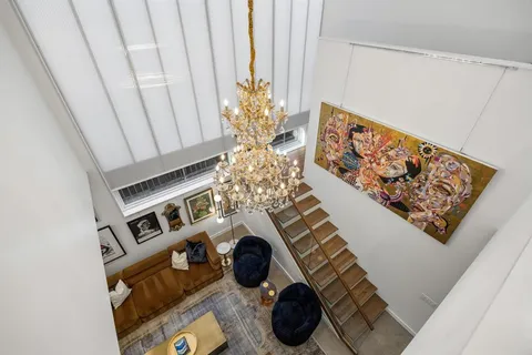 a view of living room with furniture and a chandelier