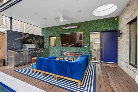 a living room with furniture fireplace and flat screen tv