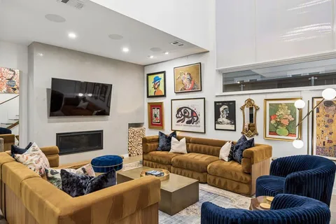 a living room with fireplace furniture and a flat screen tv