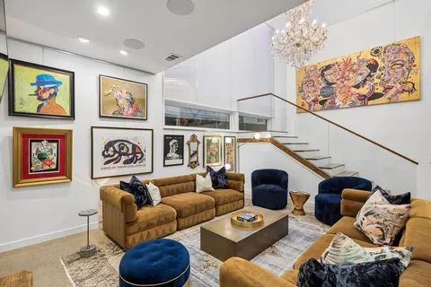 a living room with furniture and a painting