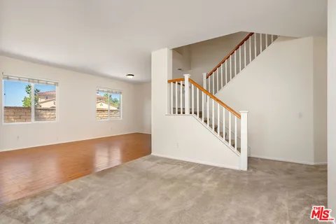 a view of a livingroom with a fireplace and window