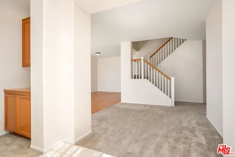a view of empty room with window and ceiling fan