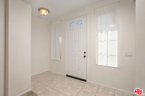 a view of a living room with a bed and a window