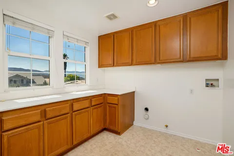 a view of a bedroom with wooden floor and a ceiling fan