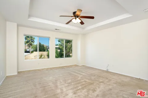 a view of a ceiling fan and a window