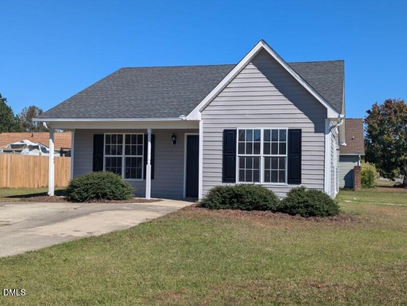 100 Reebe Circle Selma, NC 27576 - Photo 3 of 19 a front view of a house with a garden