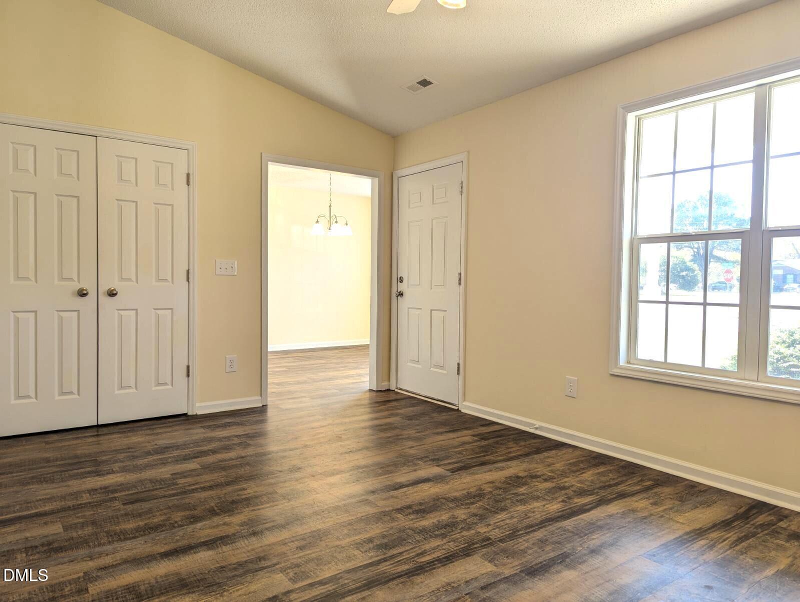 100 Reebe Circle Selma, NC 27576 - Photo 7 of 19 a view of an empty room with wooden floor with windows