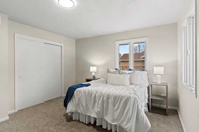 a bedroom with a bed and a window
