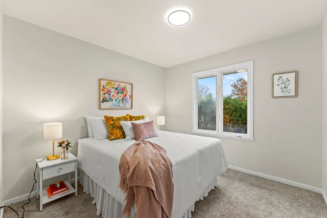 a bedroom with a bed and a window