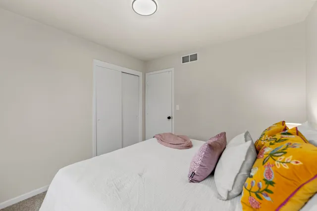 a bedroom with a bed and a couch