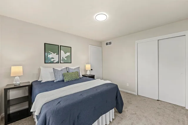 a bedroom with a bed and a night stand