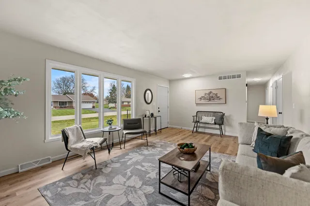 a living room with furniture and a floor to ceiling window