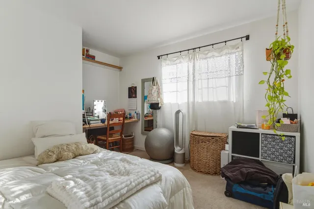 a bedroom with a bed and a couch