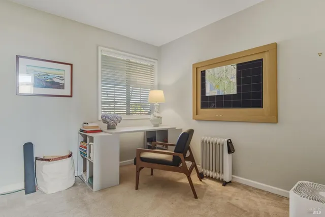 a living room with furniture a window and a lamp