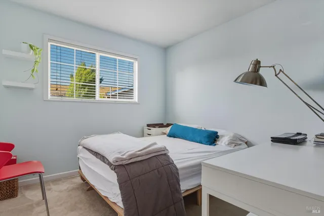 a bedroom with a bed and a table