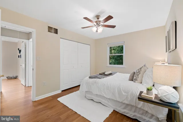 a bedroom with a bed and wooden floor