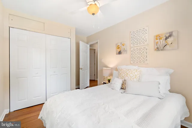 a bedroom with a bed and a painting on the wall