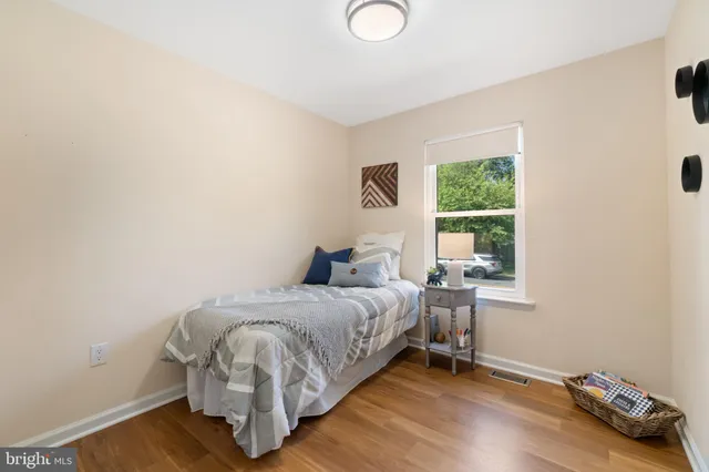 a bed sitting in a bedroom next to a window
