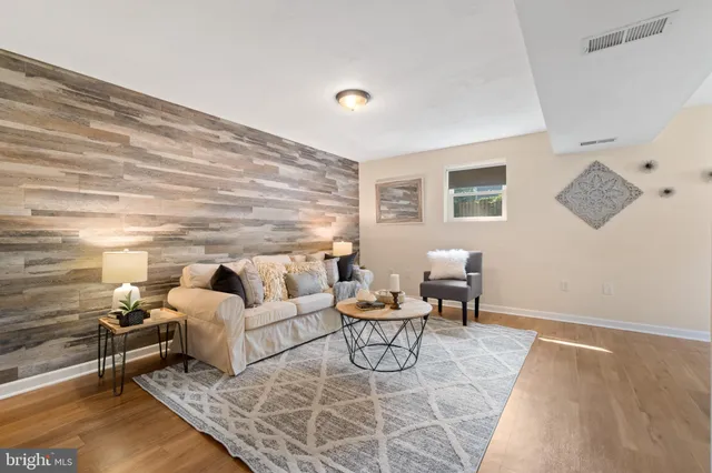 a living room with furniture and wooden floor