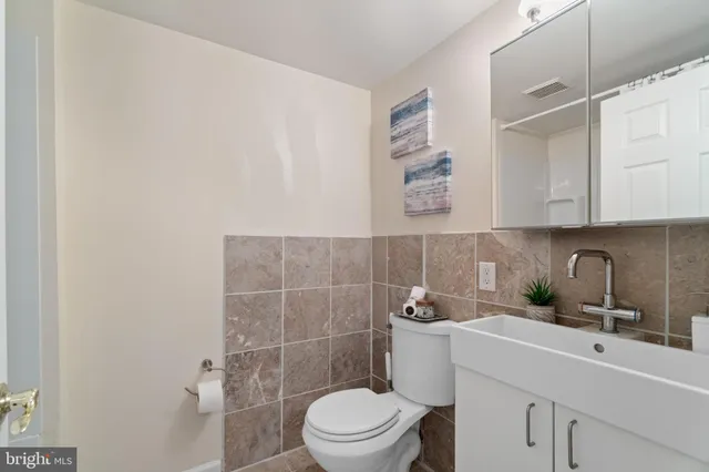 a view of a hallway with wooden floor and stairs